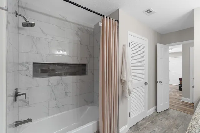 a bathroom with a shower and a tub