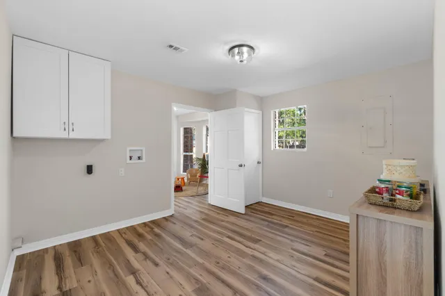 a view of an empty room and wooden floor