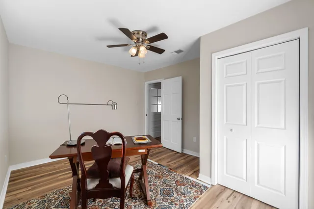 a view of a dining room with furniture and a chandelier