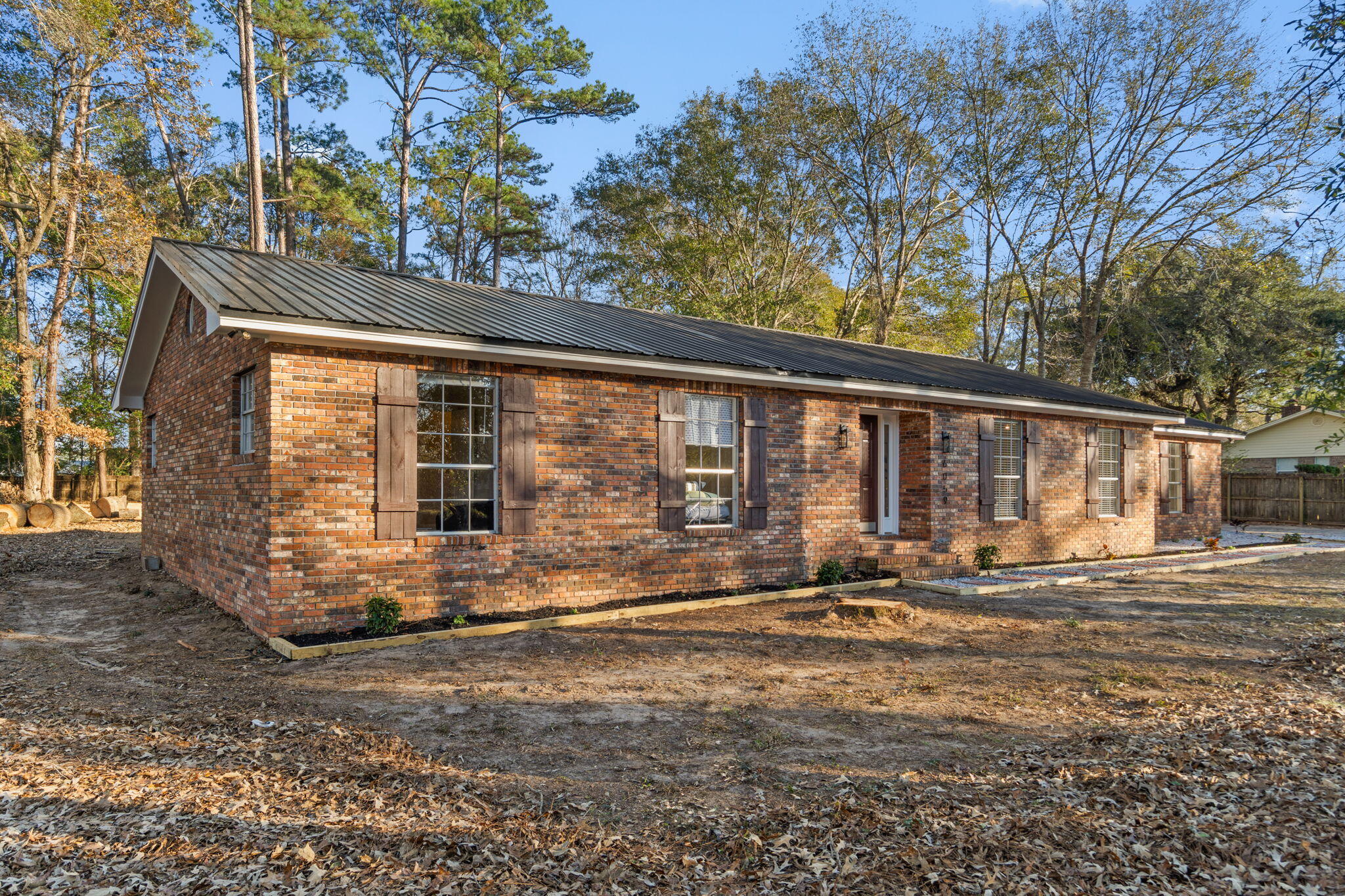 6059 Blueberry Lane Crestview, FL 32536 - Photo 5 of 36 a backyard of a house with yard and outdoor seating