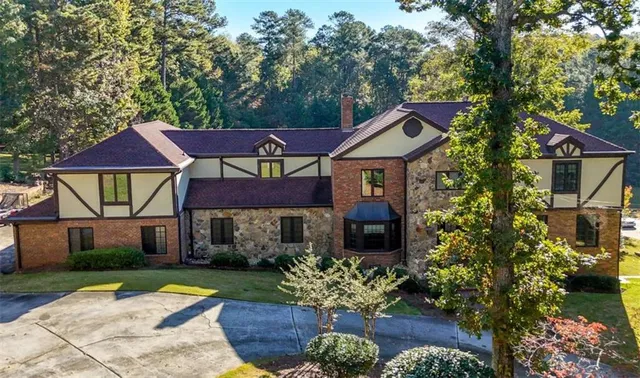 a front view of a house with a yard and table and chair