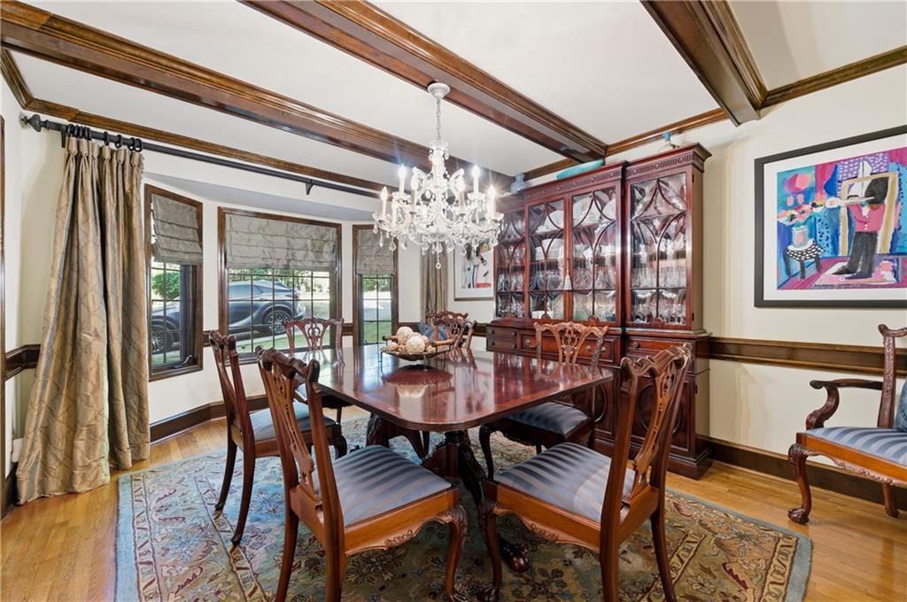 4220 Greentree Lane Southwest Atlanta, GA 30349 - Photo 17 of 42 a view of a dining room with furniture a chandelier and wooden floor
