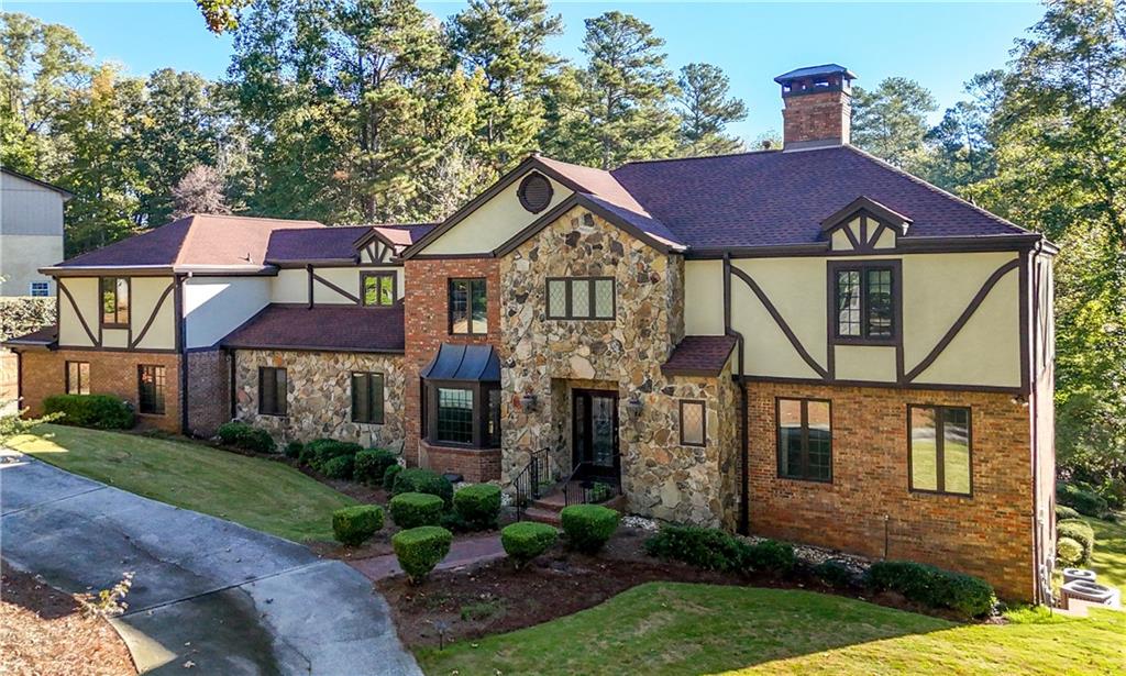 4220 Greentree Lane Southwest Atlanta, GA 30349 - Photo 2 of 42 a front view of a house with garden