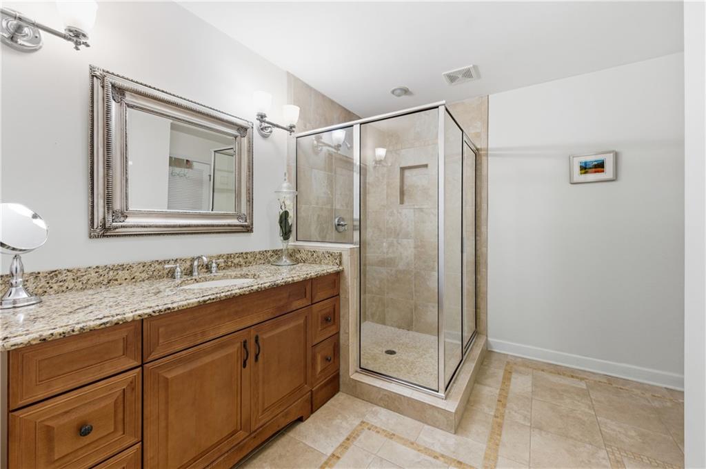4220 Greentree Lane Southwest Atlanta, GA 30349 - Photo 29 of 42 a bathroom with a shower sink and mirror