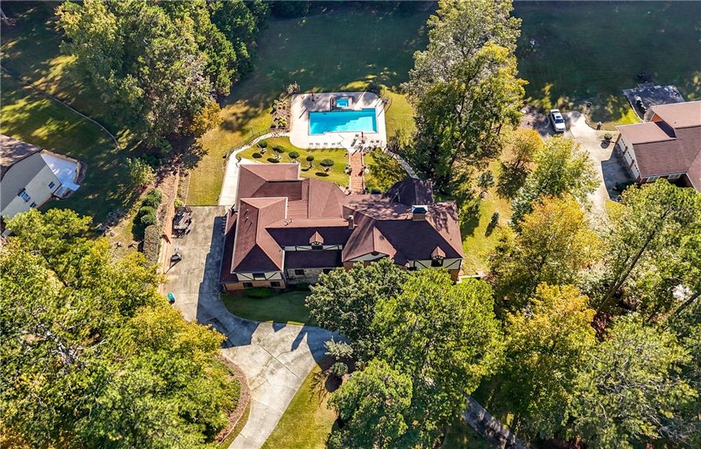 4220 Greentree Lane Southwest Atlanta, GA 30349 - Photo 5 of 42 an aerial view of a house with a yard and large trees