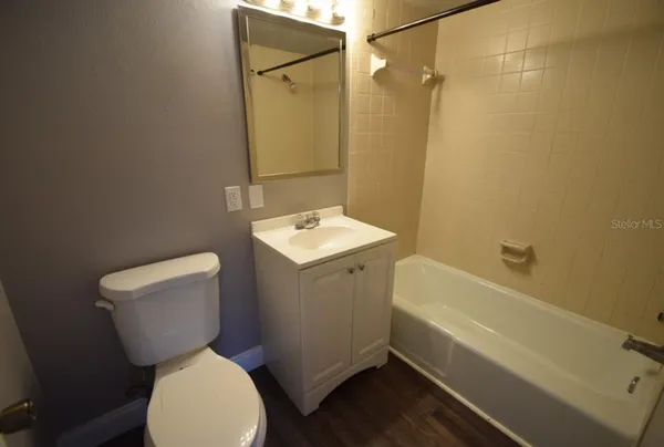 a bathroom with a toilet sink and shower