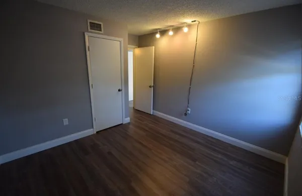 a view of hallway with wooden floor