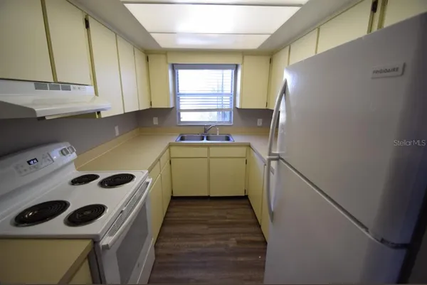 a utility room with cabinets washer and dryer
