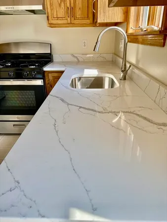 a kitchen with a sink and a stove top oven