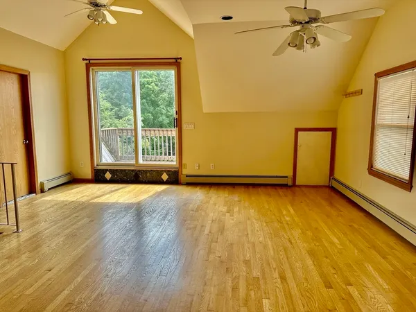 an empty room with a empty space and windows