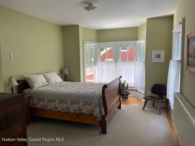 a view of a hallway with wooden floor and closet