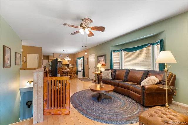 a living room with furniture and a chandelier
