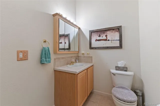 a bathroom with a toilet a sink and mirror