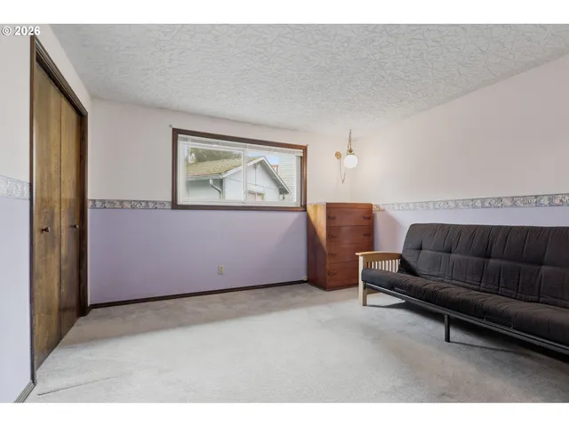 a view of an empty room with closet area