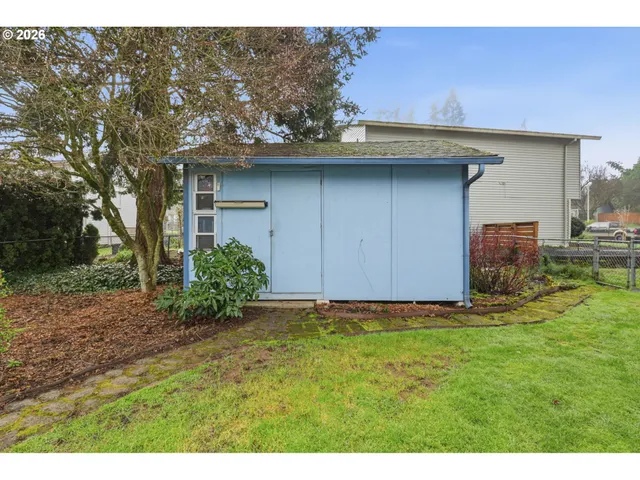 a view of a house with a yard and sitting area