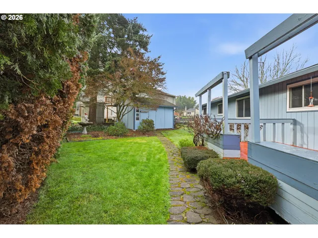 a view of backyard with a deck and wooden floor
