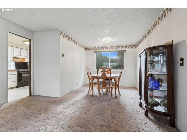 a kitchen with cabinets appliances and a window