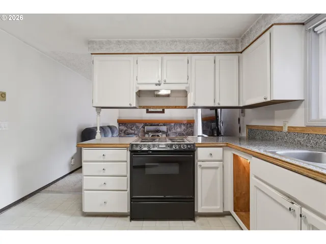 a kitchen with stainless steel appliances granite countertop a stove and cabinets