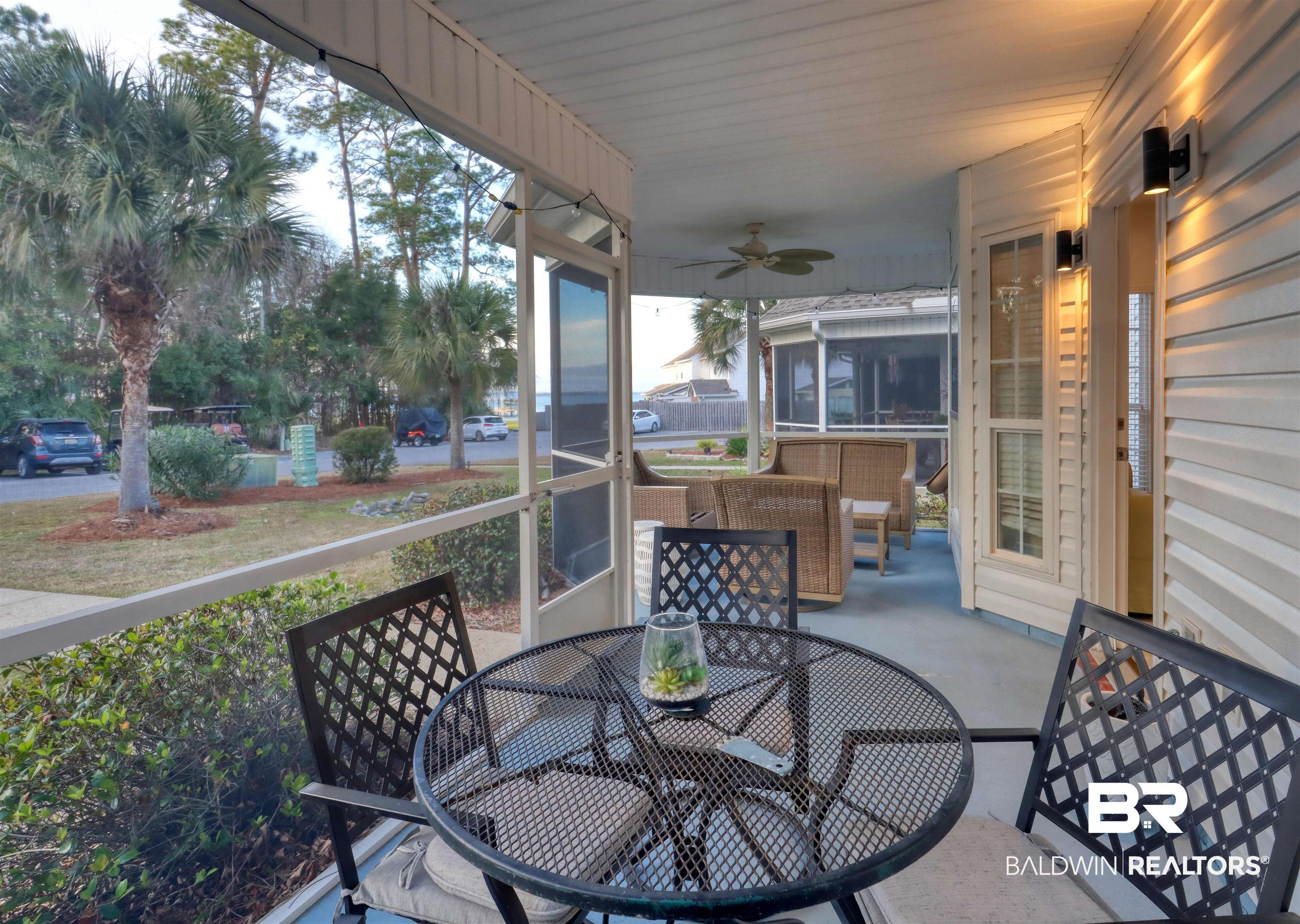 26063 Canal Road, Unit C2 Orange Beach, AL 36561 - Photo 2 of 30 Sunroom / solarium featuring a ceiling fan and outdoor dining area