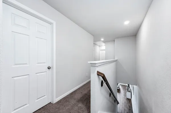 a view of a hallway with staircase