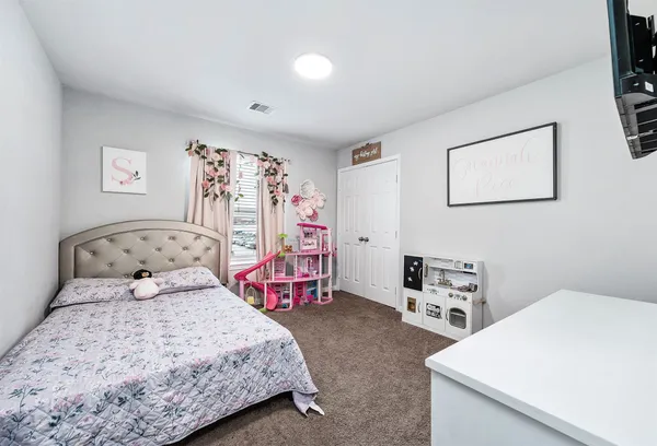 a bedroom with a bed and a tv in it