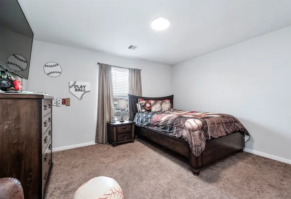 a bed sitting in a bedroom next to a window