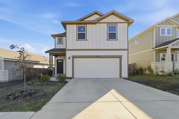 a view of a house with a yard and garage