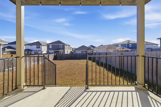 a view of balcony with a floor to ceiling window and wooden fence