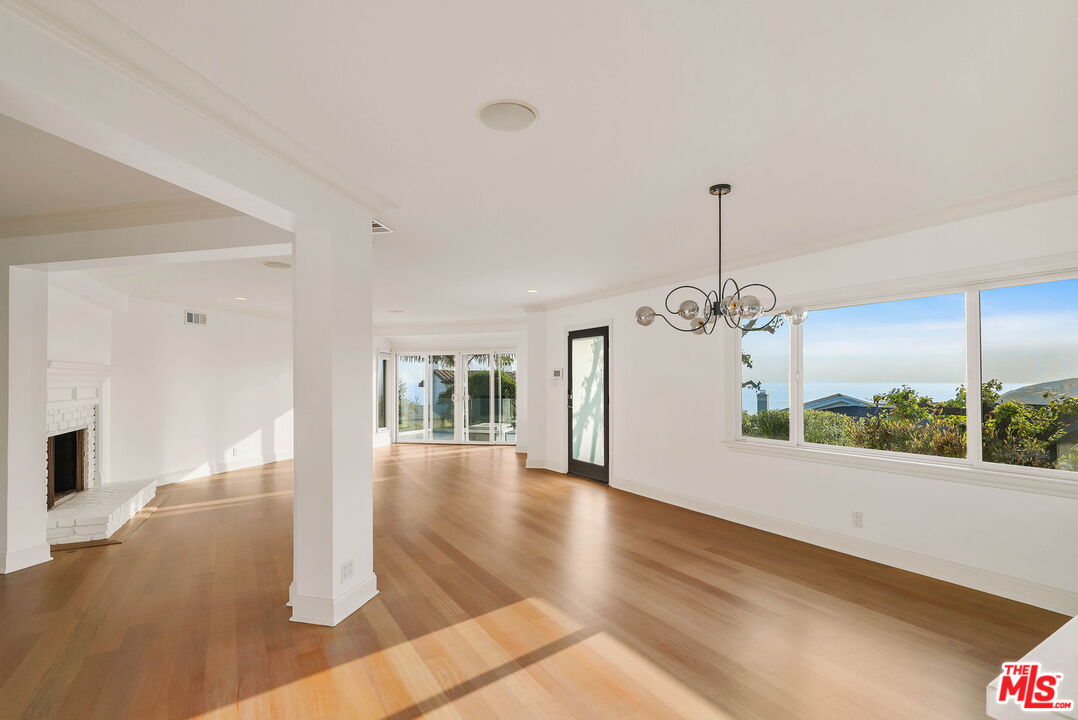 204 Tranquillo Road Pacific Palisades, CA 90272 - Photo 11 of 34 a view of a big room with wooden floor windows and chandelier