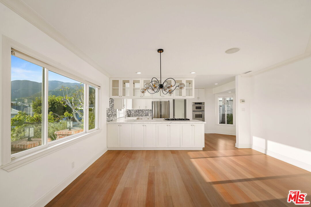 204 Tranquillo Road Pacific Palisades, CA 90272 - Photo 15 of 34 a living room with stainless steel appliances kitchen island granite countertop furniture and a view of living room