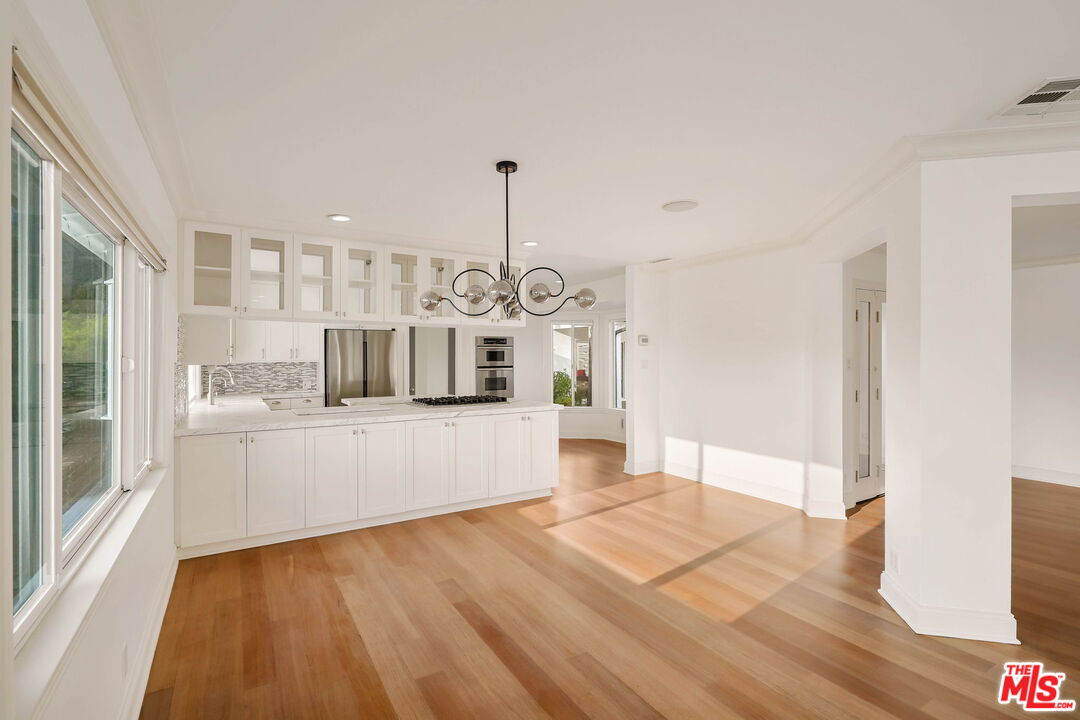 204 Tranquillo Road Pacific Palisades, CA 90272 - Photo 16 of 34 a large white kitchen with cabinets a sink and dishwasher