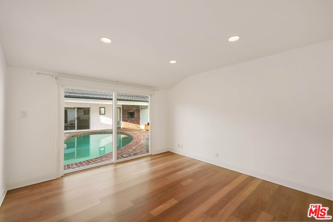 204 Tranquillo Road Pacific Palisades, CA 90272 - Photo 24 of 34 an empty room with wooden floor and windows