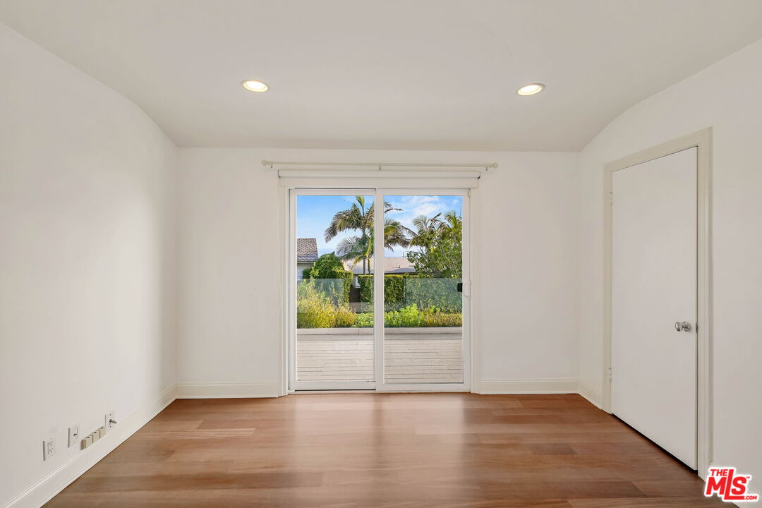 204 Tranquillo Road Pacific Palisades, CA 90272 - Photo 25 of 34 a view of an empty room with wooden floor and a window
