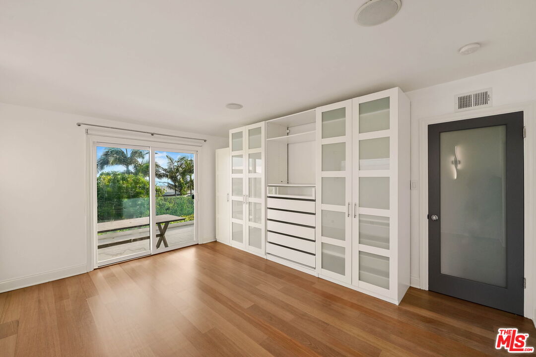 204 Tranquillo Road Pacific Palisades, CA 90272 - Photo 28 of 34 an empty room with wooden floor and windows