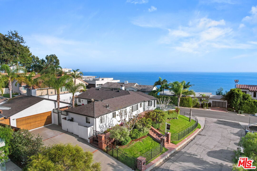 204 Tranquillo Road Pacific Palisades, CA 90272 - Photo 5 of 34 a view of a garden with a building in the background