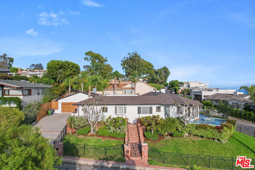 204 Tranquillo Road Pacific Palisades, CA 90272 - Photo 9 of 34 a front view of house with yard and green space