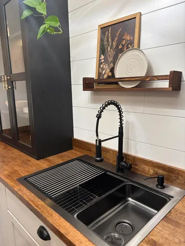 a large kitchen with lot of counter space and wooden floor