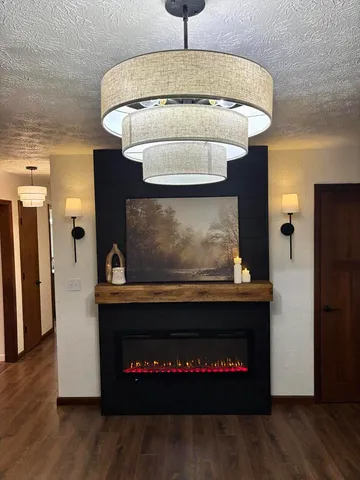 a kitchen with a stove and a wooden floor