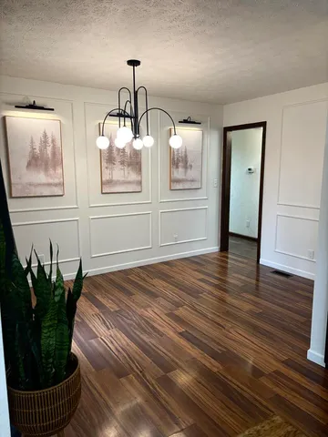 a view of a room with wooden floor and potted plant