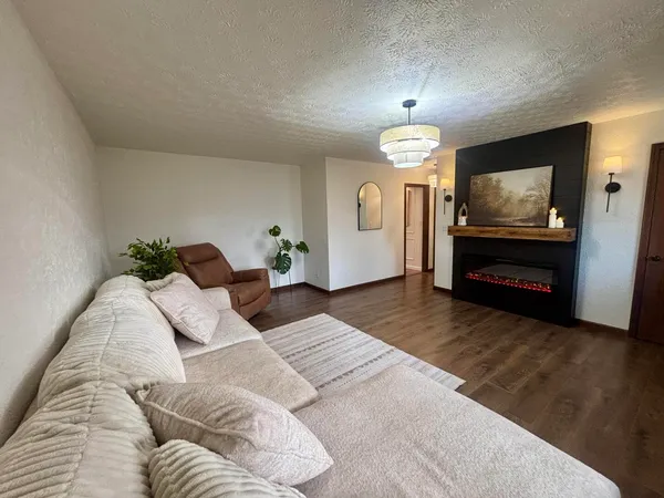 a bedroom with a bed and a chandelier