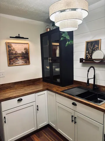 a kitchen with sink and cabinets