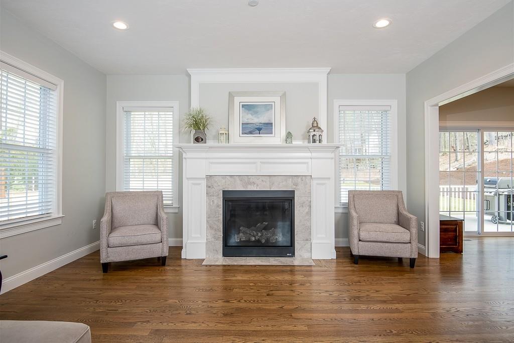 222 Sugar Road Bolton, MA 01740 - Photo 11 of 36 a living room with furniture and a fireplace