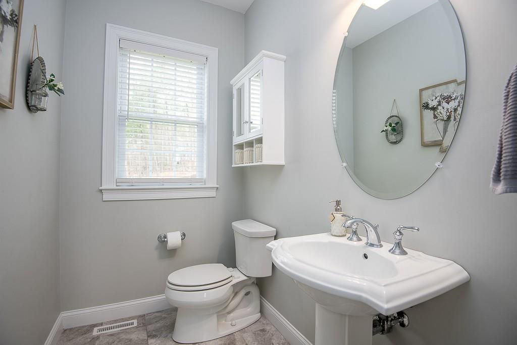 222 Sugar Road Bolton, MA 01740 - Photo 16 of 36 a bathroom with a toilet sink and mirror
