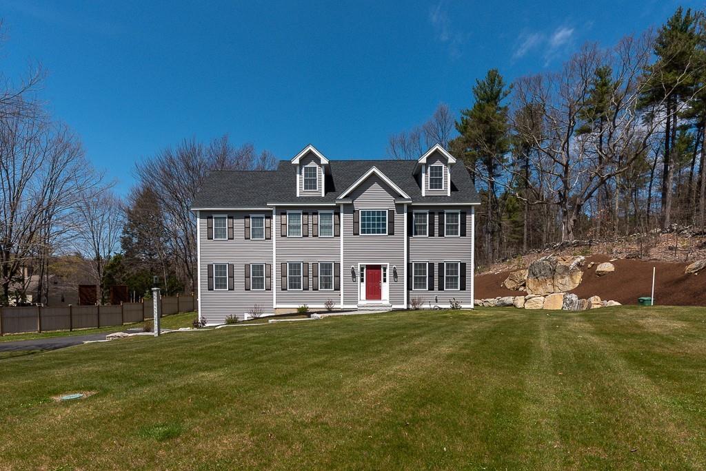 222 Sugar Road Bolton, MA 01740 - Photo 2 of 36 a front view of a house with a garden and trees