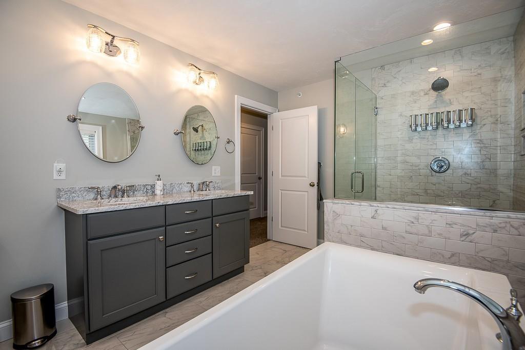 222 Sugar Road Bolton, MA 01740 - Photo 21 of 36 a bathroom with a double vanity sink mirror and bathtub
