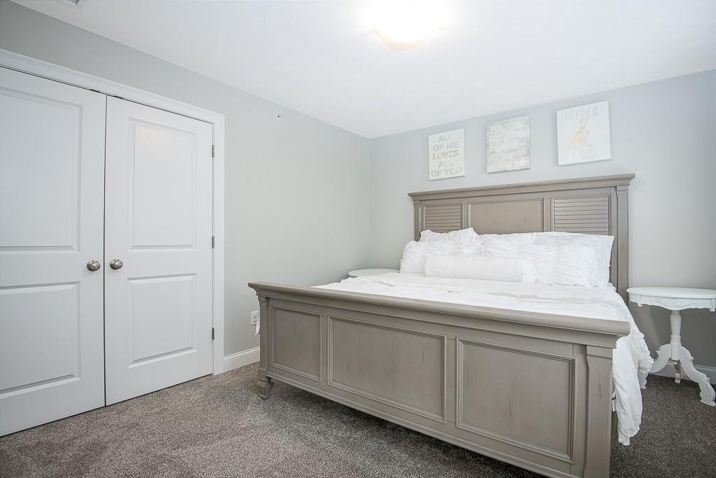 222 Sugar Road Bolton, MA 01740 - Photo 22 of 36 a room with a bed and a cabinets