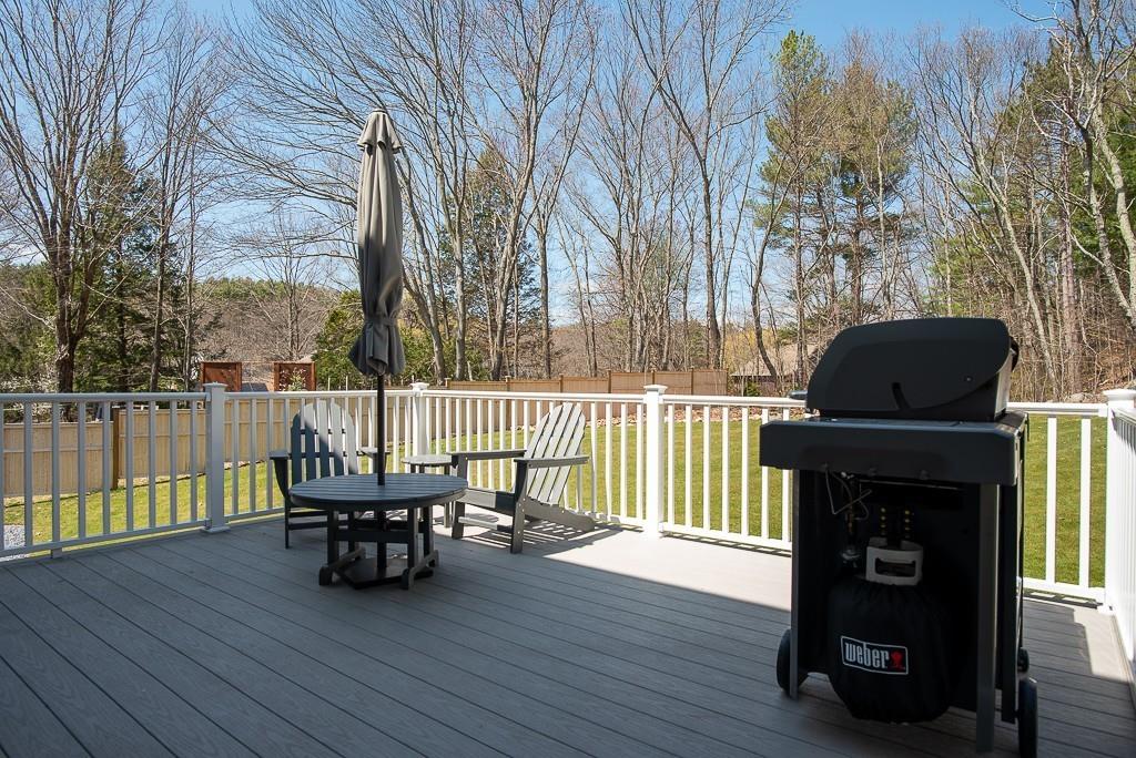 222 Sugar Road Bolton, MA 01740 - Photo 28 of 36 a roof deck with table and chairs and wooden floor
