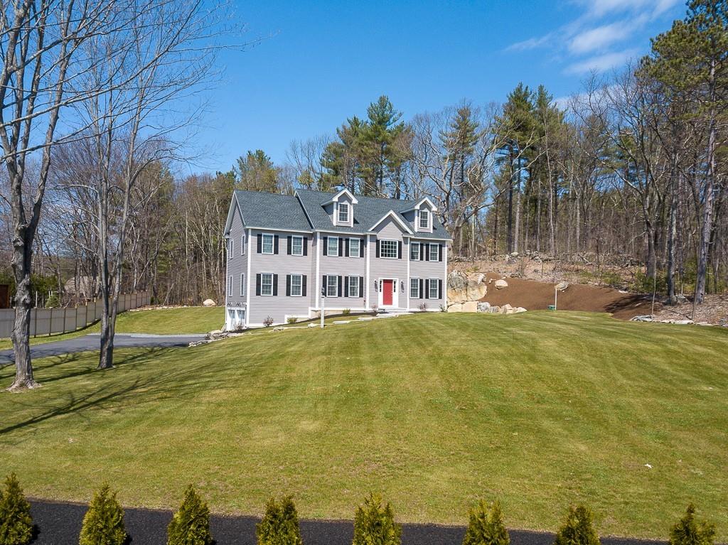 222 Sugar Road Bolton, MA 01740 - Photo 3 of 36 a view of a swimming pool with a house in the background