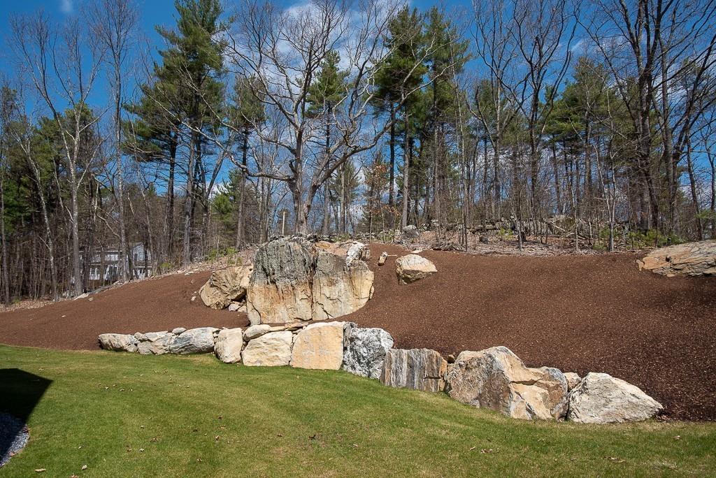 222 Sugar Road Bolton, MA 01740 - Photo 31 of 36 a view of a lake with a yard