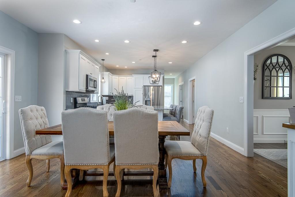 222 Sugar Road Bolton, MA 01740 - Photo 7 of 36 a view of a dining room with furniture and wooden floor